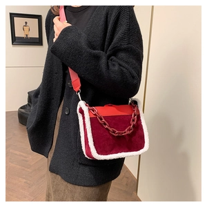 Detail of burgundy lamb wool patchwork crossbody bag with resin chain and fabric strap