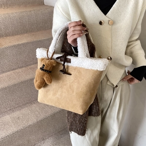 Chic sherpa-trimmed suede tote bag with toggle closure and cute teddy bear pendant