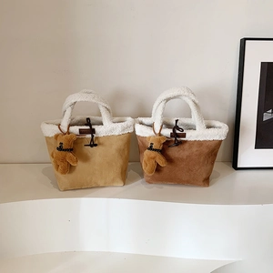 Faux suede bucket handbag with white lamb wool trim and plush bear charm for autumn winter