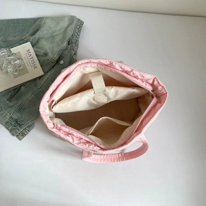 Pink quilted tote bag interior with laptop compartment and secure velcro strap