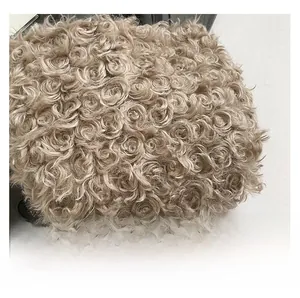 Close-up of curly faux lamb wool fabric with soft texture on a stylish tote bag