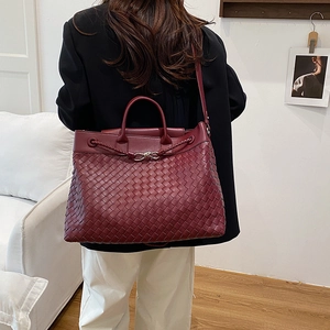 Handwoven burgundy leather tote bag with top handle and crossbody strap for elegant women