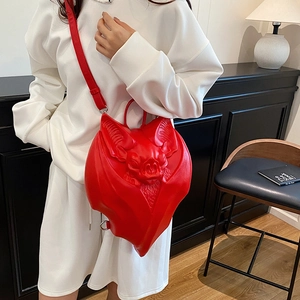 Bright red 3D bat shaped backpack in matte leather with adjustable straps for women