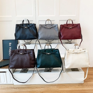 Hand-woven leather tote bags in six colors with metallic buckles and shoulder straps