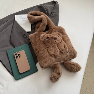 Chic brown plush teddy bear tote bag on an oversized grey blazer in a stylish setting