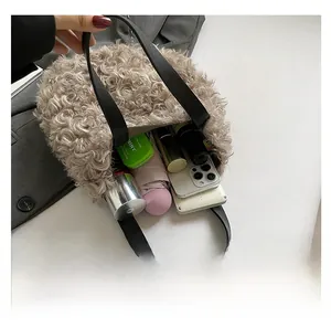 Internal view of khaki fuzzy tote bag showing large capacity for phone and umbrella