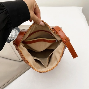 Handwoven brown bucket bag featuring a spacious interior with a secure zipper pocket