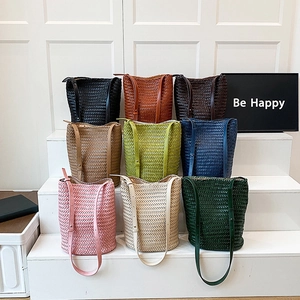 Hand-woven tote bags displayed in nine colors with V-pattern texture and long straps