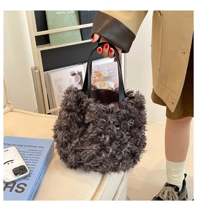Close-up of curly faux fur tote bag with black leather handles and spacious interior