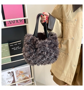 Detail of dark brown plush tote bag with premium faux fur texture and black leather handles