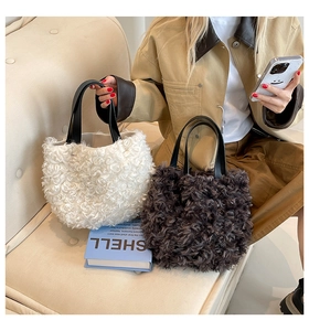 Close-up of plush faux fur tote bags in beige and brown with black leather handles