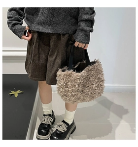 Detail of child model carrying the soft brown teddy plush handbag with black handles