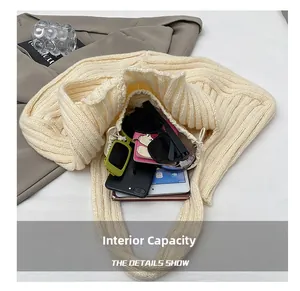 Detail showing large capacity of the beige knit tote bag with tablet and accessories
