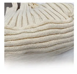 Close-up of cream knit fabric showing soft ribbed texture and premium material detail