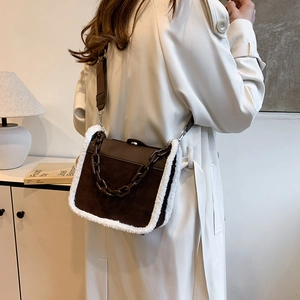 Brown suede shoulder bag with plush shearling trim and dark brown acrylic chain decoration