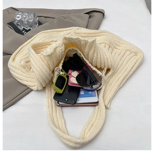 Top view of cream knitted tote bag showing spacious interior with daily essentials