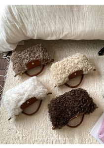 Detail of four fuzzy lamb wool crossbody bags in neutral tones with leather flaps