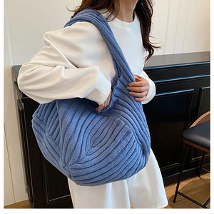 Detail of blue rib-knit tote bag showing large capacity and soft textured material