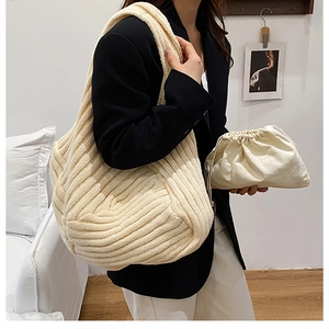 Beige knit hobo shoulder bag and matching drawstring pouch with woven texture