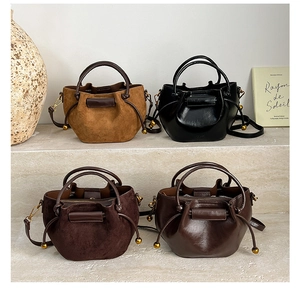 Detailed comparison of minimalist bucket bags in smooth and matte leather finishes