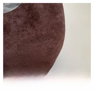 Close-up of deep brown suede texture showing fine frosted finish on a tote bag
