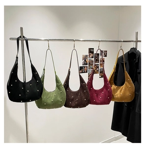 Group view of five suede moon bags in various colors with metallic silver studs details