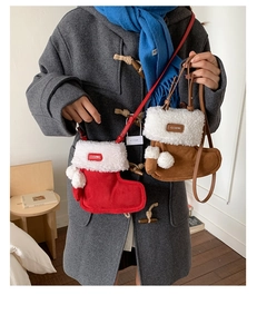 Detail of plush Christmas stocking crossbody bags in red and brown with fuzzy white pom-poms