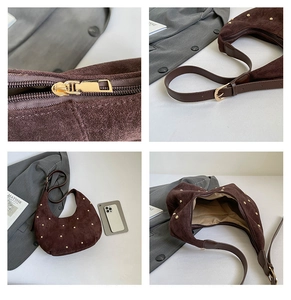 Detail of brown suede crescent bag with gold studs, adjustable strap and interior lining
