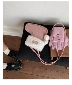 Pink plush crossbody bag paired with matching knit gloves on a cozy lifestyle background