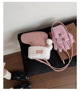 Close-up of pink faux suede boot-shaped bag and matching ribbed knit fingerless gloves