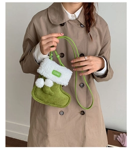 Detail showing creative green suede sock-shaped bag with white faux shearling trim