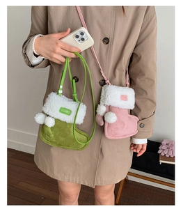 Detail of pink and green plush boot-shaped crossbody bags with soft fur trim and pom-poms