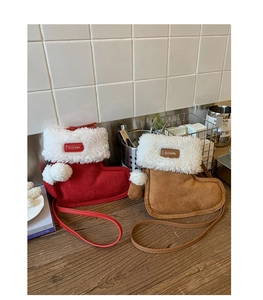 Detail of Christmas stocking shaped faux suede crossbody bags with plush trim and pom-poms