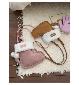 Detail of pink and brown faux suede Christmas boot bags with soft plush trim