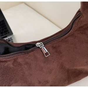 Macro shot of durable metal zipper and suede texture on vintage dark brown tote bag