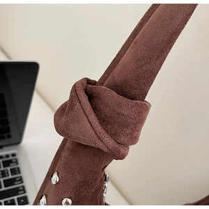 Detail of brown faux suede tote bag featuring thick rope knot strap and silver metal rivets