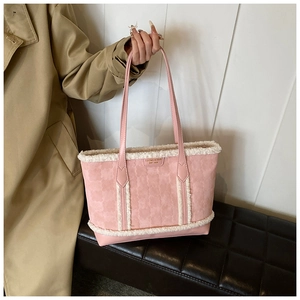Close-up of pink tote bag with white plush trim and embossed floral textures
