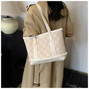 Detail of winter tote bag featuring beige plush stitching and floral texture design