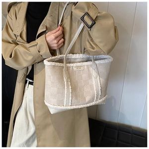 Detail of winter tote bag featuring clover texture and soft faux fur trim accents