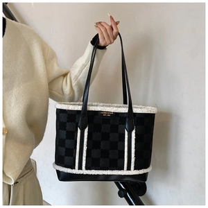 Detail of plush faux fur patchwork on a large tote bag with luxury leather handles