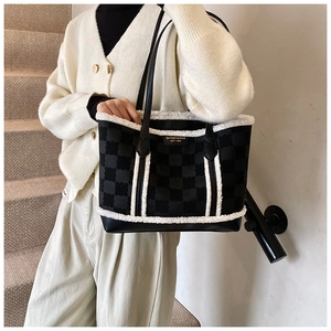 Detailed view of winter tote bag featuring plush faux fur trim and checkered texture