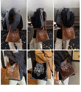 Detail of embroidered bohemian hobo bags in coffee and black colors shown on model