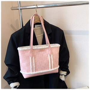 Close-up of pink embossed clover tote bag featuring white faux shearling trim details
