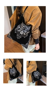 Close-up of bohemian floral embroidery on a large black shoulder tote bag for women