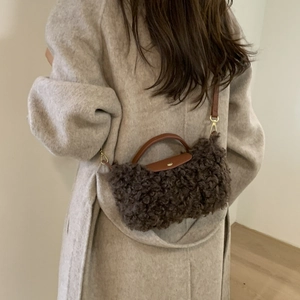 Brown faux fur crossbody bag with leather flap and handle for a minimalist winter style