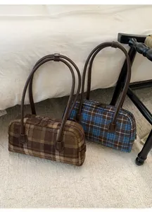Detail of retro checkered barrel bags in tweed material with slim leather straps