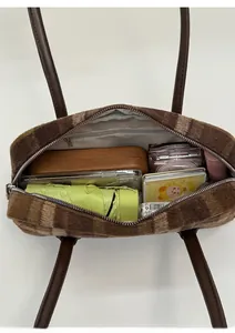 Interior view of striped plush tote bag showing capacity for umbrella and wallet