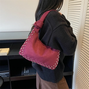 Vintage burgundy suede baguette bag with silver studs and knotted handle detail