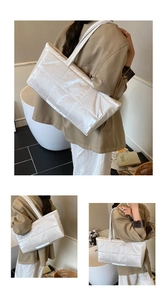 Silver quilted down cotton tote bag showing detailed metallic texture and shoulder straps