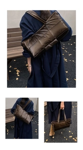 Detail of dark brown quilted puffer tote bag with metallic finish and spacious design